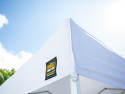 White 10x10 Compact Shelter canopy in sunlight, showing cooling benefits and UPF 50+ sun protection